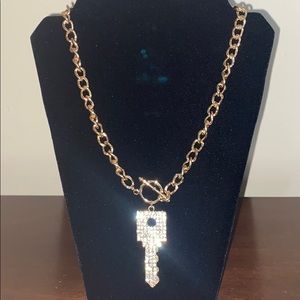 Goldtone necklace with key pendant